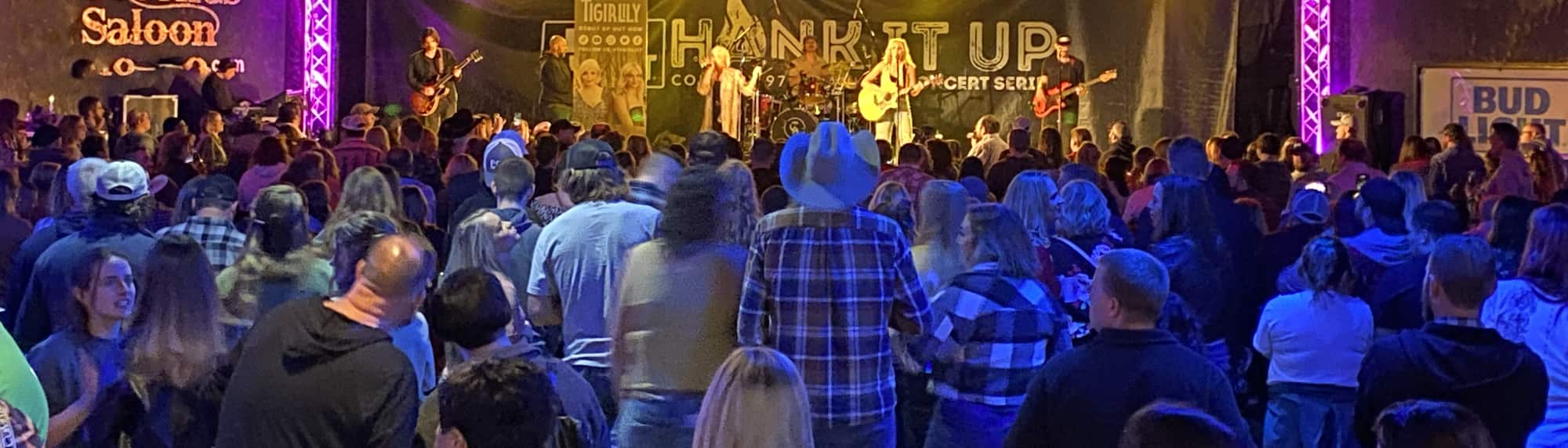country concert with fans wearing cowboy hats Syracuse