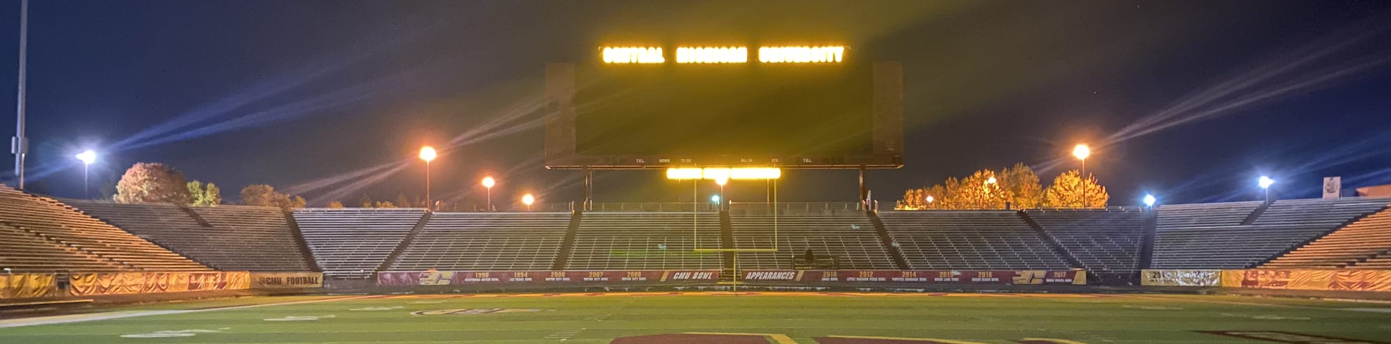 empty football stadium at night under the lights Syracuse